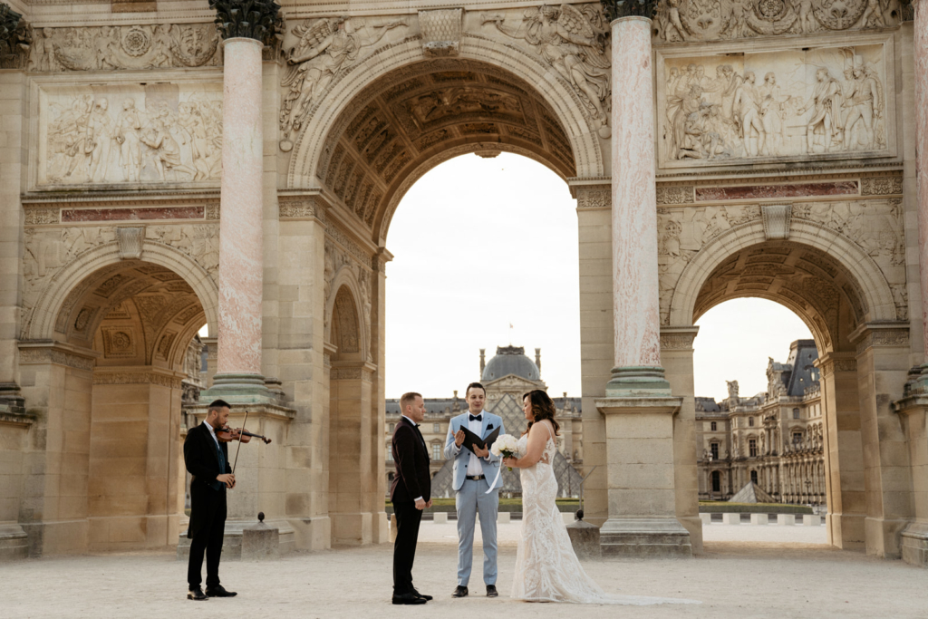 elopement wedding ceremony at the louvre carrousel in Paris, we can see an english speaking officiant, the couple and a violinist named Rafael