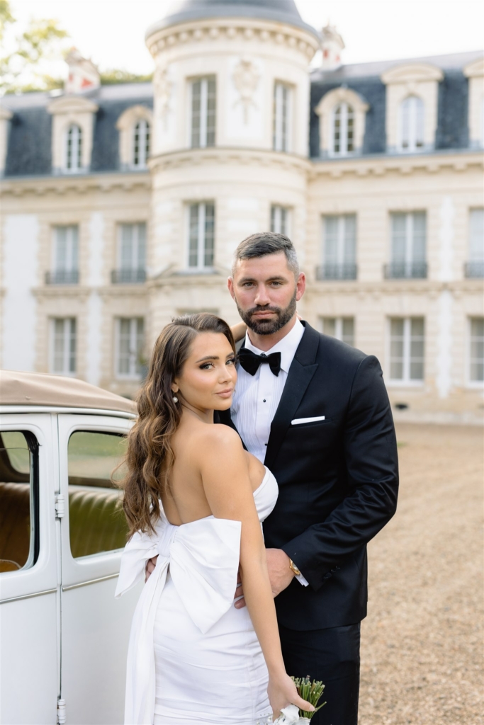 paris wedding couple standing in front of the chateau