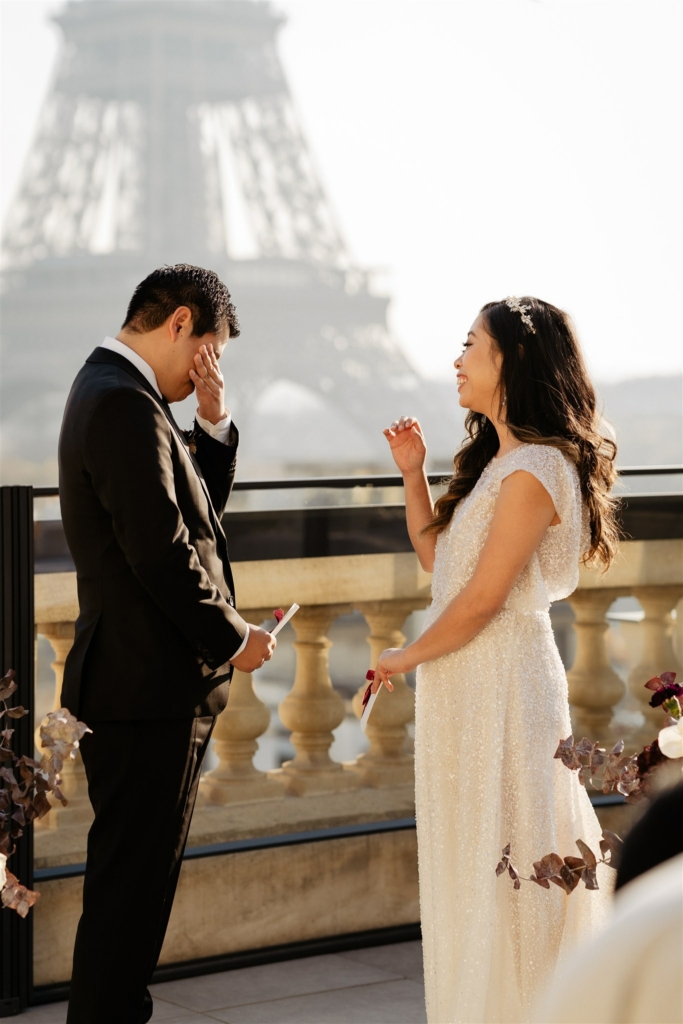 wedding ceremony taking place at the shangri la hotel in Paris. THe groom is emotional for his vows, the eiffel tower views are amazing
